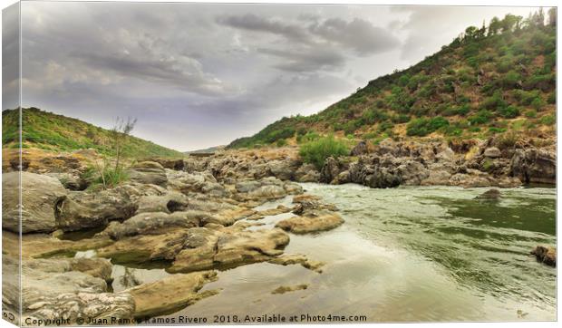  Guadiana river going down between the rocks and m Canvas Print by Juan Ramón Ramos Rivero
