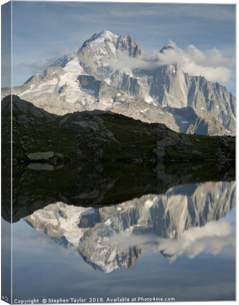 The Dru reflected in Lac des Cheserys Canvas Print by Stephen Taylor