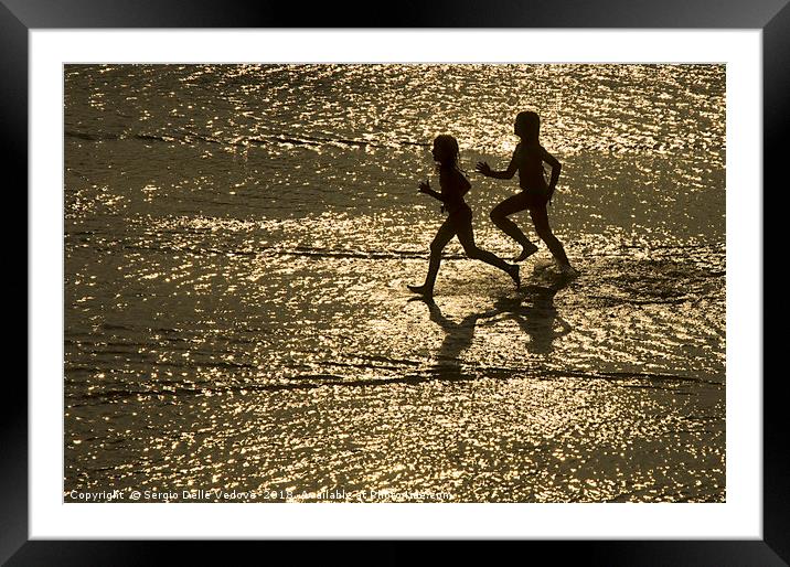 two children run by the sea Framed Mounted Print by Sergio Delle Vedove