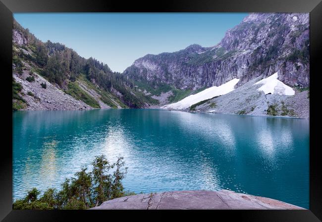 Glacier lake with mountains and snow during summer Framed Print by Thomas Baker