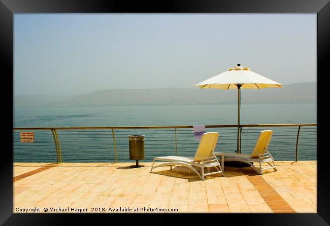 Sun beds and Brolly on the shores of Galilee Framed Print by Michael Harper