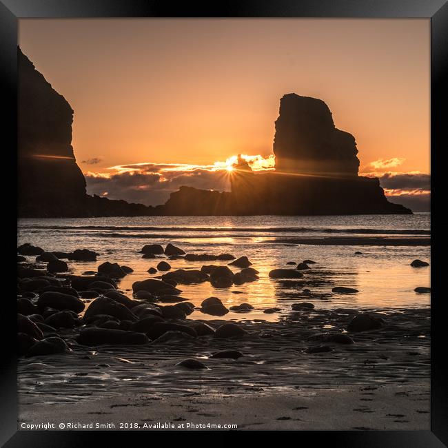 Setting sun beyond the seastack at Talisker Point Framed Print by Richard Smith