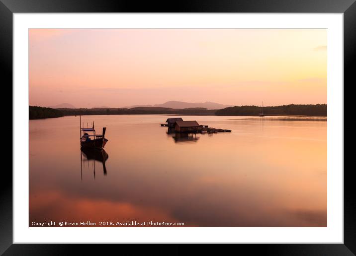 Boat and fish hut on river estuary Framed Mounted Print by Kevin Hellon