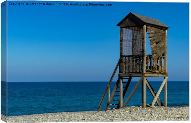 A rustic wooden lifeguard's hut on a shingle beach Canvas Print by Stephen Robinson