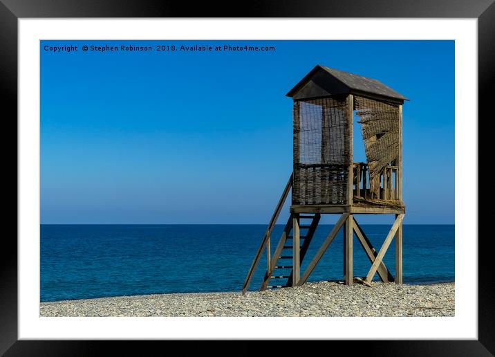 A rustic wooden lifeguard's hut on a shingle beach Framed Mounted Print by Stephen Robinson
