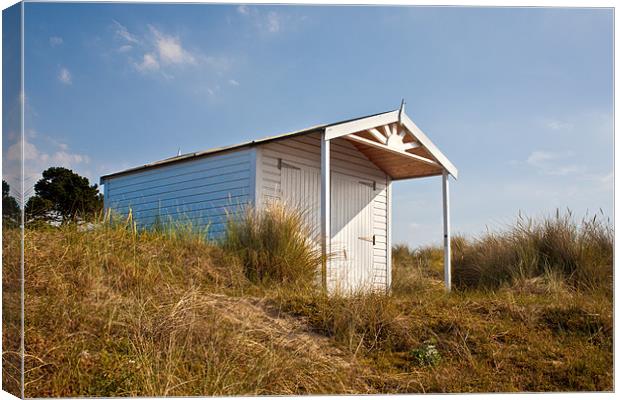A Beach hut in the Marram Grass at Old Hunstanton, Canvas Print by John Edwards
