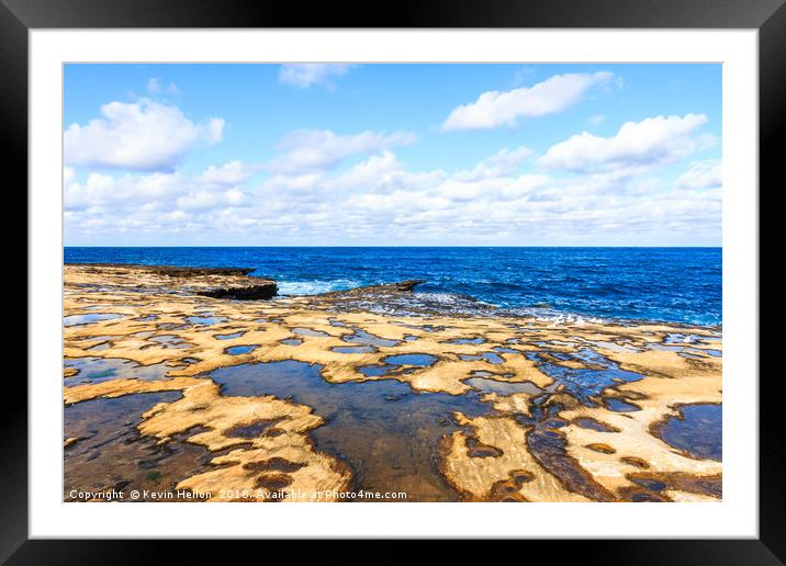 Looking out to sea over the rock pools Framed Mounted Print by Kevin Hellon