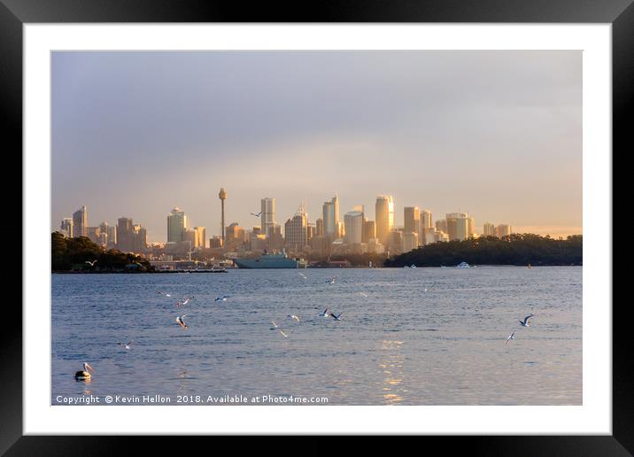 A flock of birds flies over the sea  Framed Mounted Print by Kevin Hellon