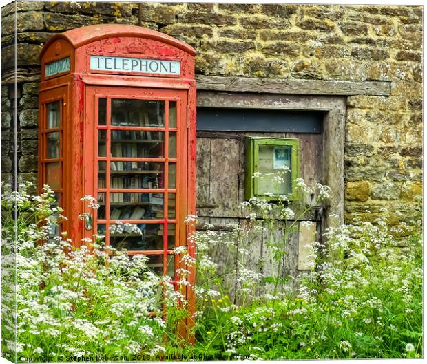 Old redundant red public telephone box or is it? Canvas Print by Stephen Robinson