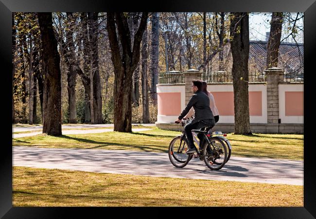 Riding A Bike In The Park Framed Print by Jukka Heinovirta