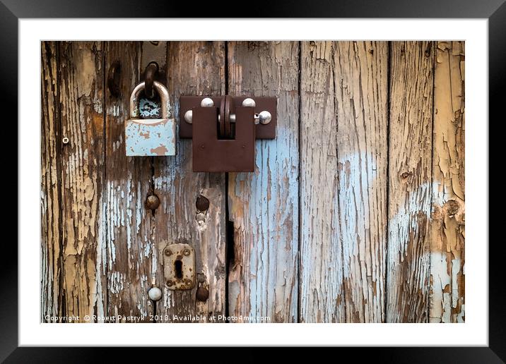 Two locks on old wooden garage door, peeling paint Framed Mounted Print by Robert Pastryk