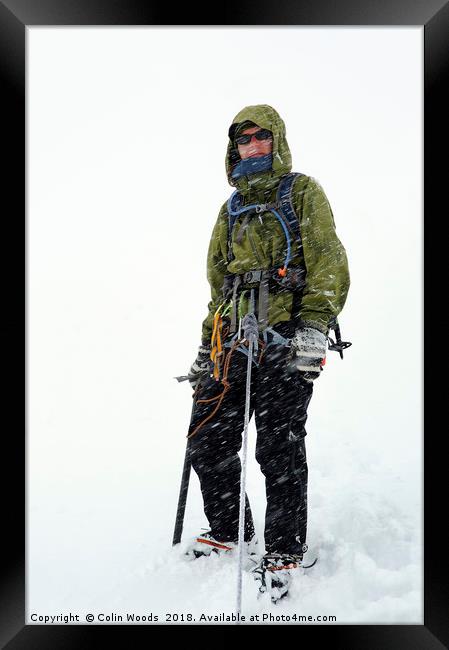 Mountaineer in a blizzard Framed Print by Colin Woods