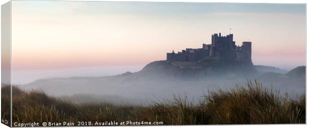 Bamburgh castle at dawn Canvas Print by Brian Pain