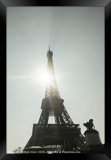 Sun shining through the Eiffel Tower Framed Print by Nick Hirst