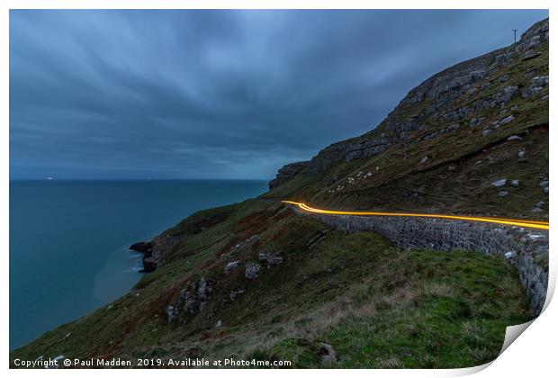 Car lights around the Great Orme Print by Paul Madden