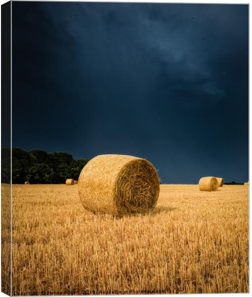 Summer Thunder Storm over the Hay bails Canvas Print by James Aston
