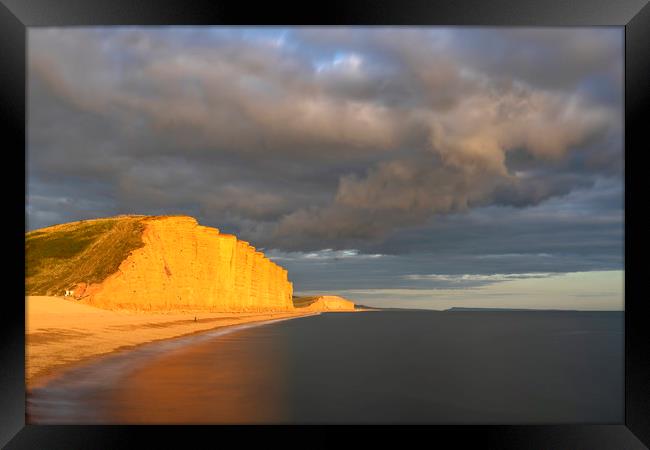Storm clouds over East Cliff (West Bay) Framed Print by Andrew Ray