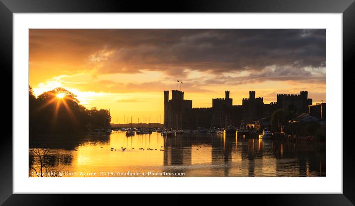 The setting sun at Caernarfon Castle Wales Framed Mounted Print by Chris Warren