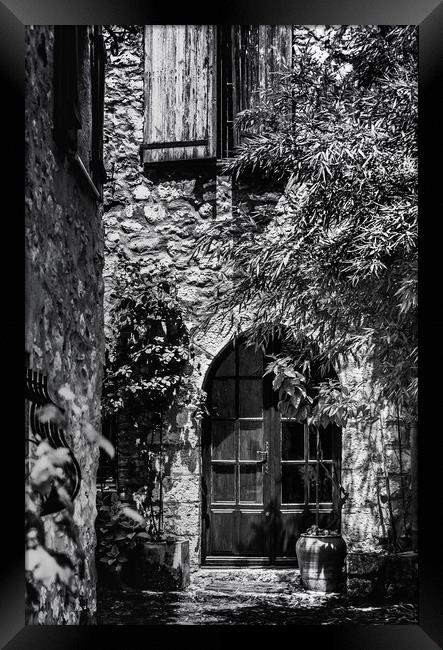 A Shadowy alley in Saint Paul de Vence France Framed Print by Maggie McCall