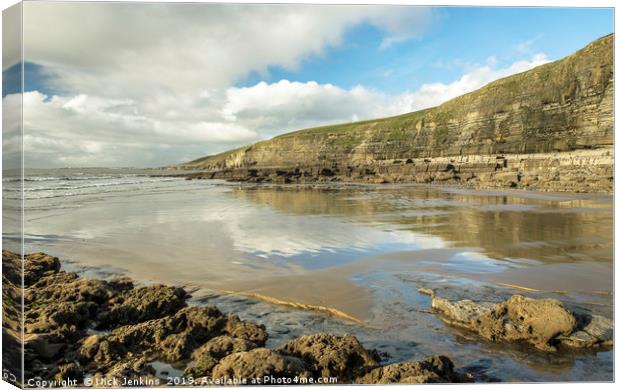 Dunraven Bay with clouds reflected on wet sand Canvas Print by Nick Jenkins
