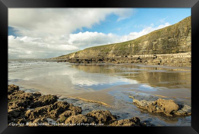 Dunraven Bay with clouds reflected on wet sand Framed Print by Nick Jenkins