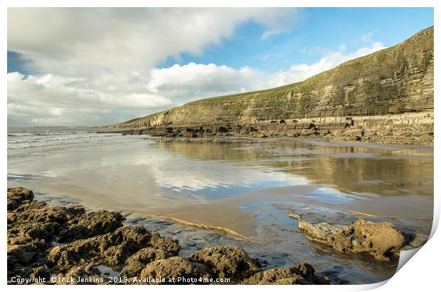 Dunraven Bay with clouds reflected on wet sand Print by Nick Jenkins