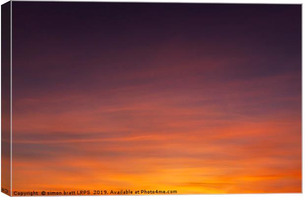 Stunning sunset colorful sky with wispy clouds Canvas Print by Simon Bratt LRPS