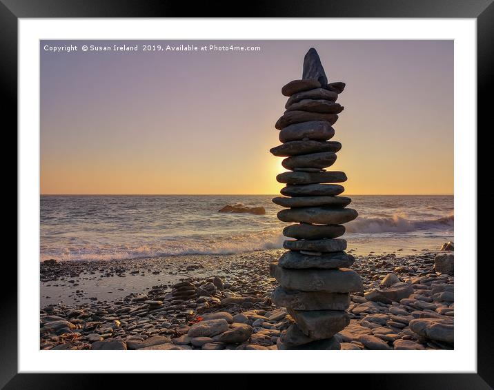 Stacked stones before a sunset  Framed Mounted Print by Susan Ireland