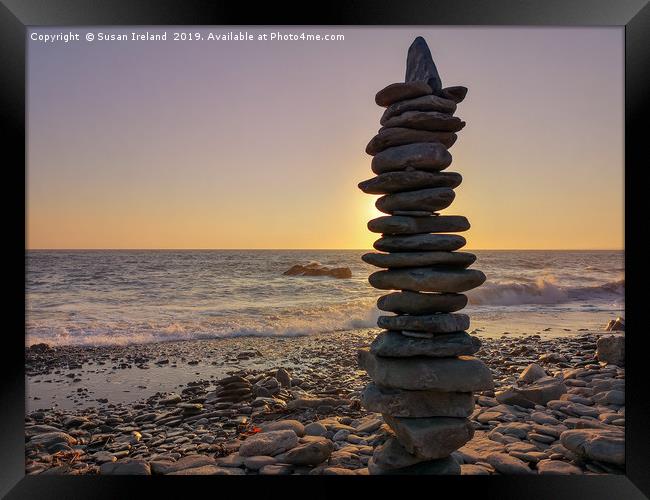 Stacked stones before a sunset  Framed Print by Susan Ireland
