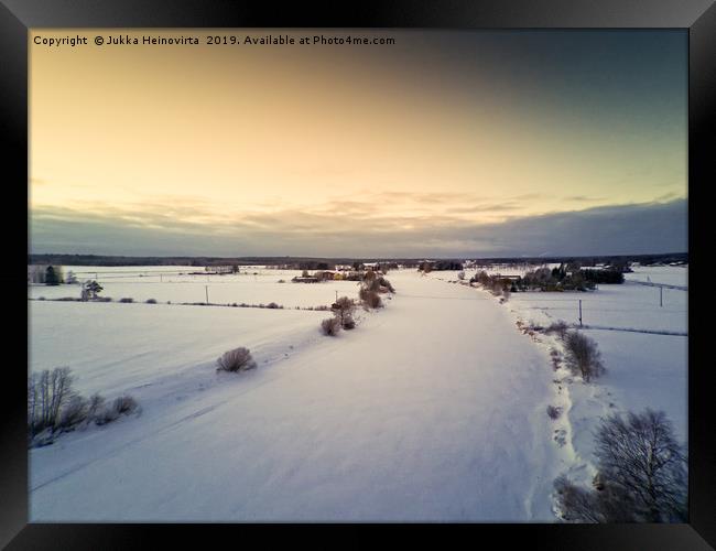 Sunset Over Icy River Bend Framed Print by Jukka Heinovirta