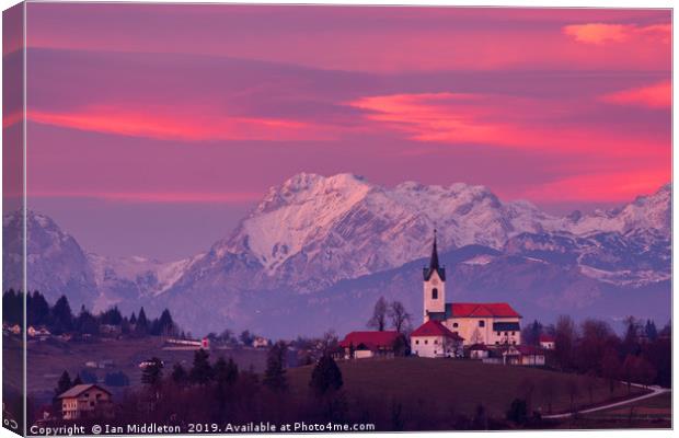 Prezganje church with snowy Kamnik Alps at sunset Canvas Print by Ian Middleton