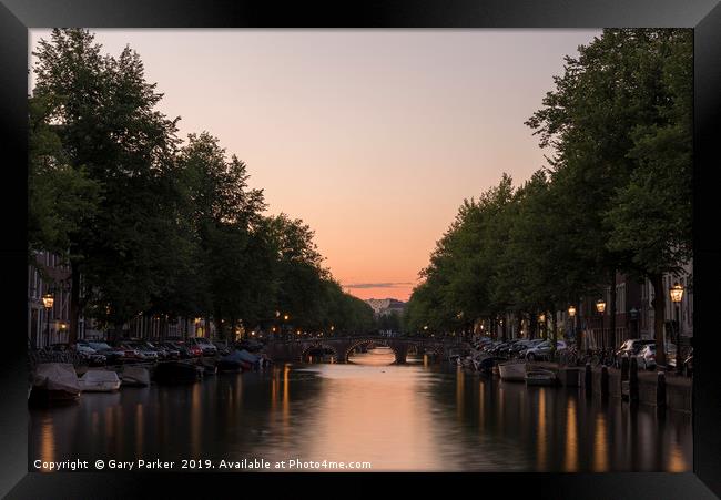 Sunset, looking down a canal in Amsterdam. Framed Print by Gary Parker