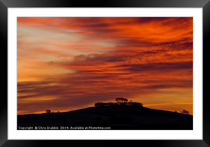 Minninglow with light from the rising sun Framed Mounted Print by Chris Drabble