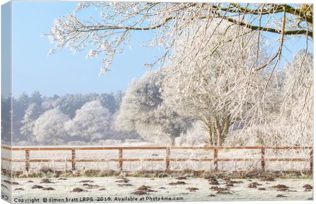 Winter scene with trees fence and mole hills Canvas Print by Simon Bratt LRPS