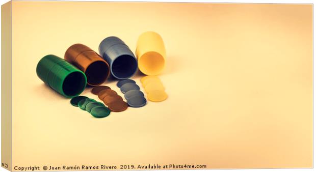 Dice cup and colored chips in row  Canvas Print by Juan Ramón Ramos Rivero
