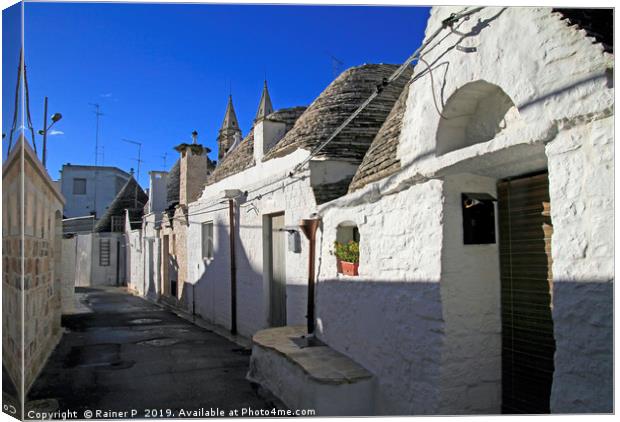 Street in Alberobello with the famous "Trulli" Canvas Print by Lensw0rld 