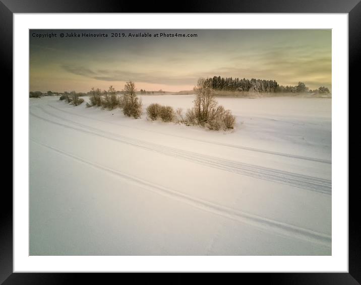 Snow Mobile Tracks On An Icy River Framed Mounted Print by Jukka Heinovirta