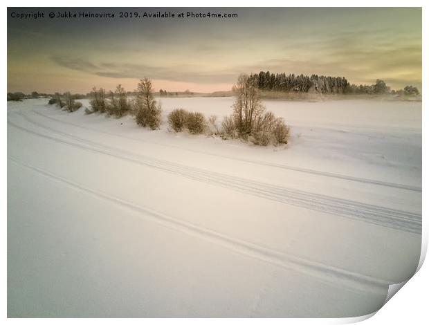 Snow Mobile Tracks On An Icy River Print by Jukka Heinovirta