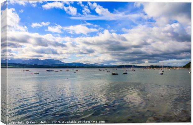 Blue sky and clouds over boats moored in the Menai Canvas Print by Kevin Hellon