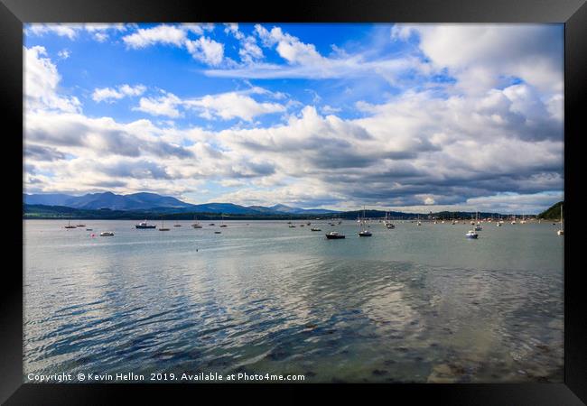 Blue sky and clouds over boats moored in the Menai Framed Print by Kevin Hellon