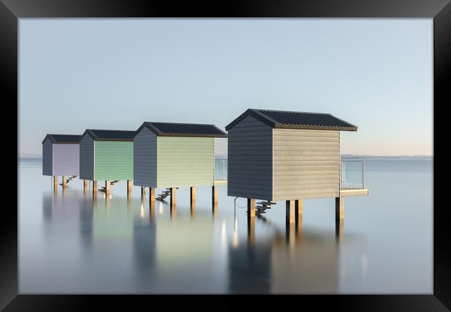 Pastel Beach Huts at high tide Framed Print by Kelvin Trundle