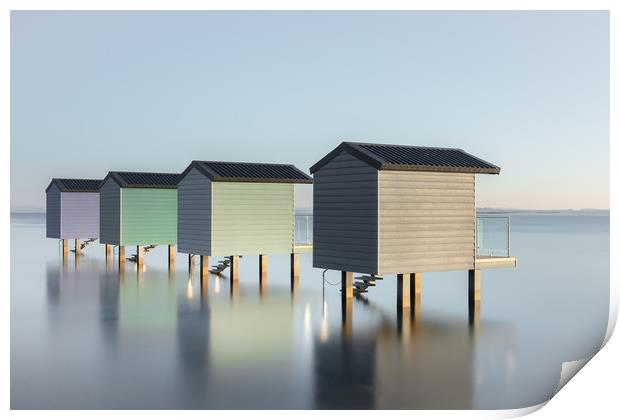 Pastel Beach Huts at high tide Print by Kelvin Trundle