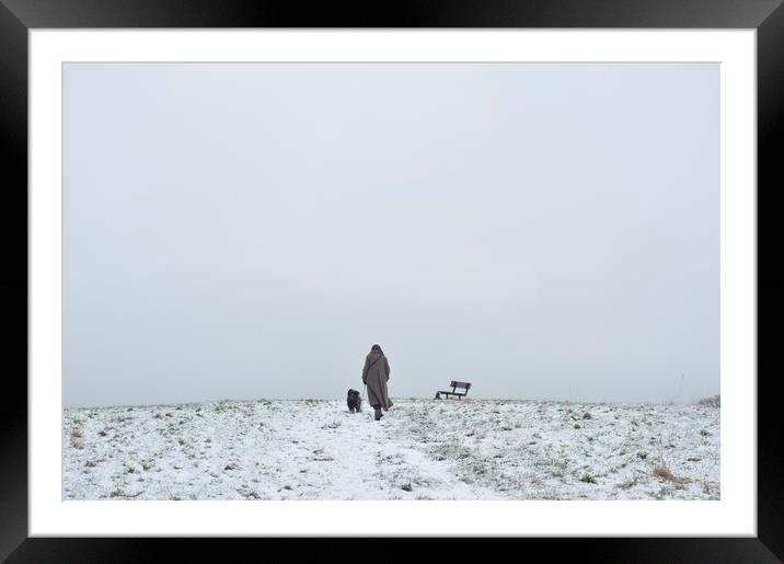 Woman walking a dog at winter time Framed Mounted Print by Ian M