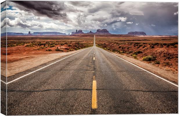 The long straight road to Monument Valley, Utah Canvas Print by Steven Clements LNPS