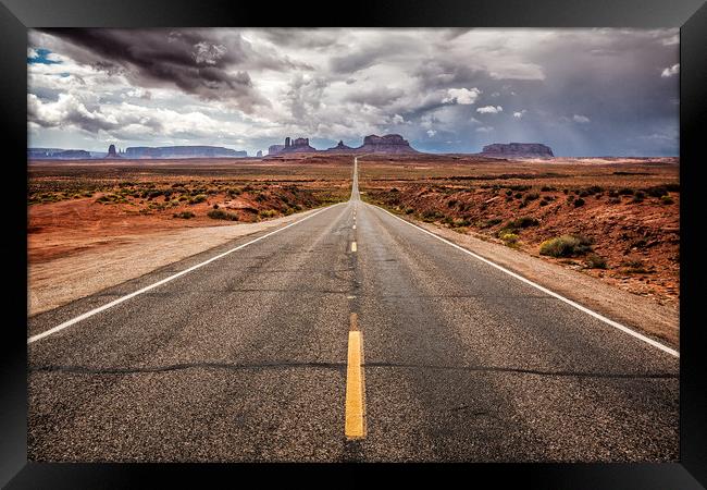 The long straight road to Monument Valley, Utah Framed Print by Steven Clements LNPS