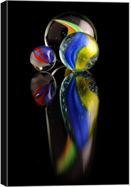 Three colourfull marbles reflecting Canvas Print by Tony Claes