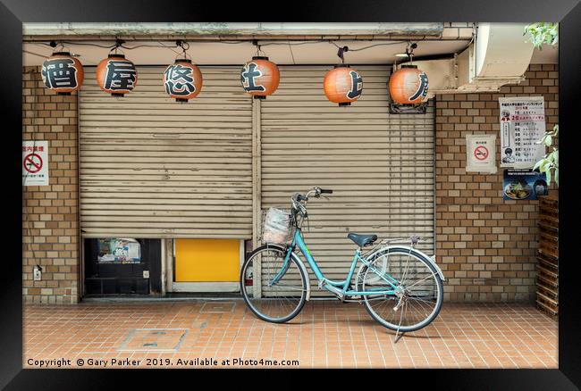 A single bicycle outside a closed shop in Tokyo Framed Print by Gary Parker