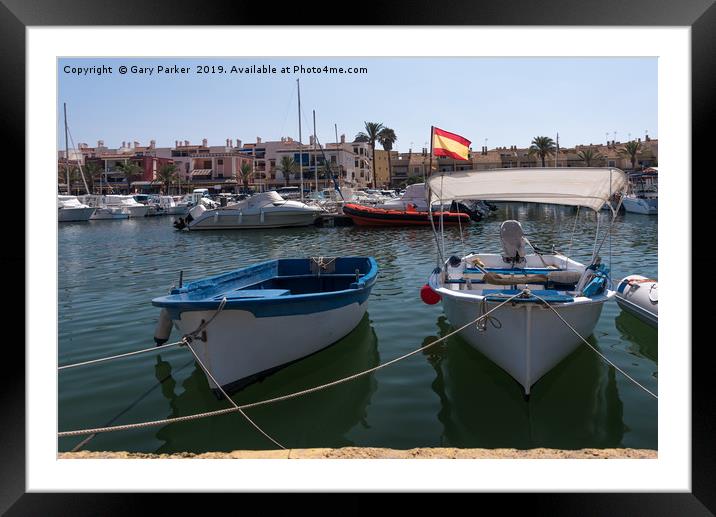 Small fishing boats moored in a Spanish harbour Framed Mounted Print by Gary Parker