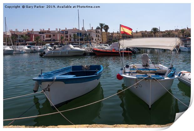 Small fishing boats moored in a Spanish harbour Print by Gary Parker