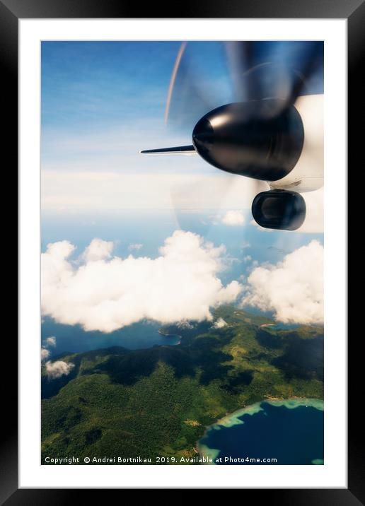 Propeller aircraft wing over tropical island Framed Mounted Print by Andrei Bortnikau